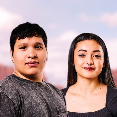 Two native teens stand side-by-side outside.